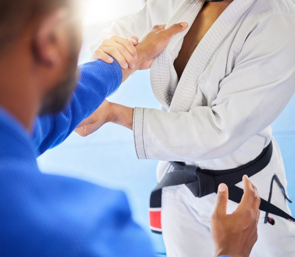 Man, closeup and karate training fight in gym, dojo and combat sport for exercise. Man, self defenc